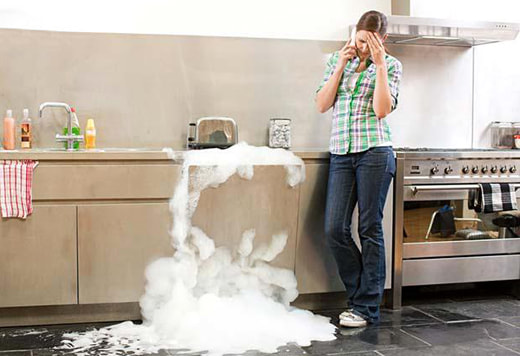 woman calling plumber because of overflowing sink 